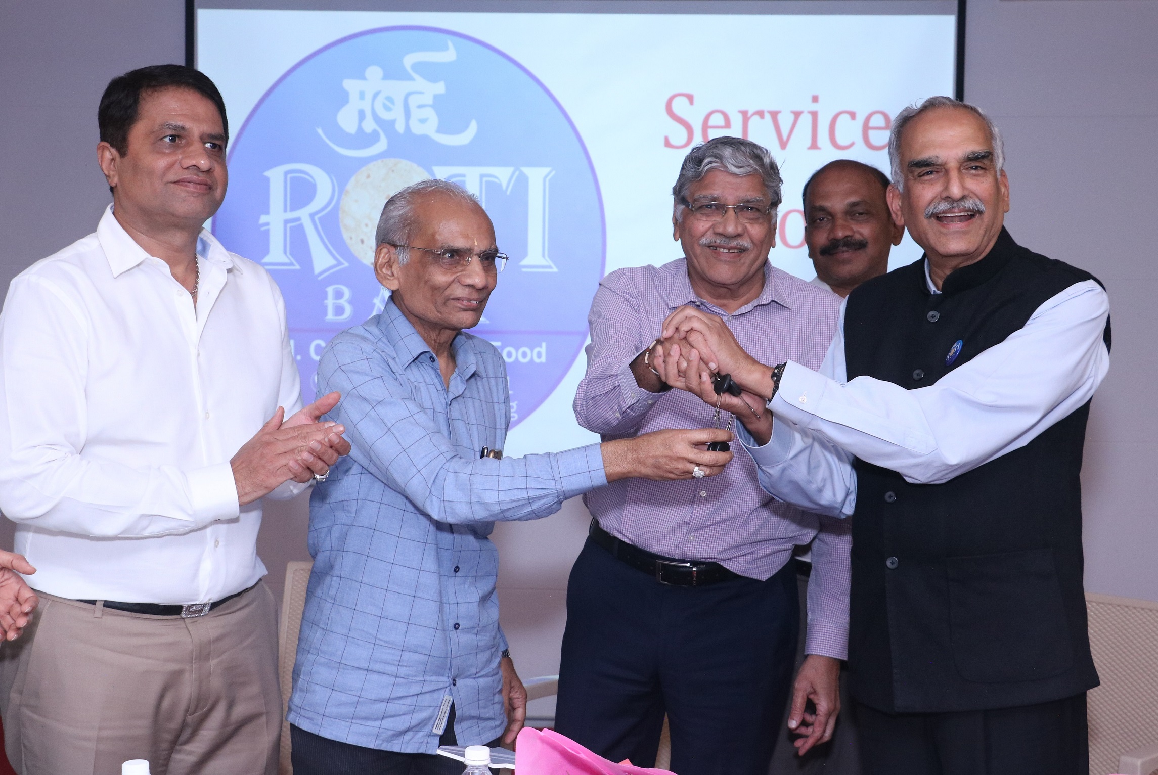 Mr Sanjay Kothari, Chairman, Gems and Jewellery National Relief Foundation (GJNRF), along with members of Bharat Diamond Bourse at a function held at the Bharat Diamond Bourse (BDB) in Mumbai held today to donate 2 vans to the Roti Bank, a non-profit organisation which thrives to make the city free of hunger and excess food to be delivered to the needy people. Shri D Sivanandhan, Mentor Roti Bank, former Commissioner of Police, Mumbai receiving the van keys.-Photo By GPN