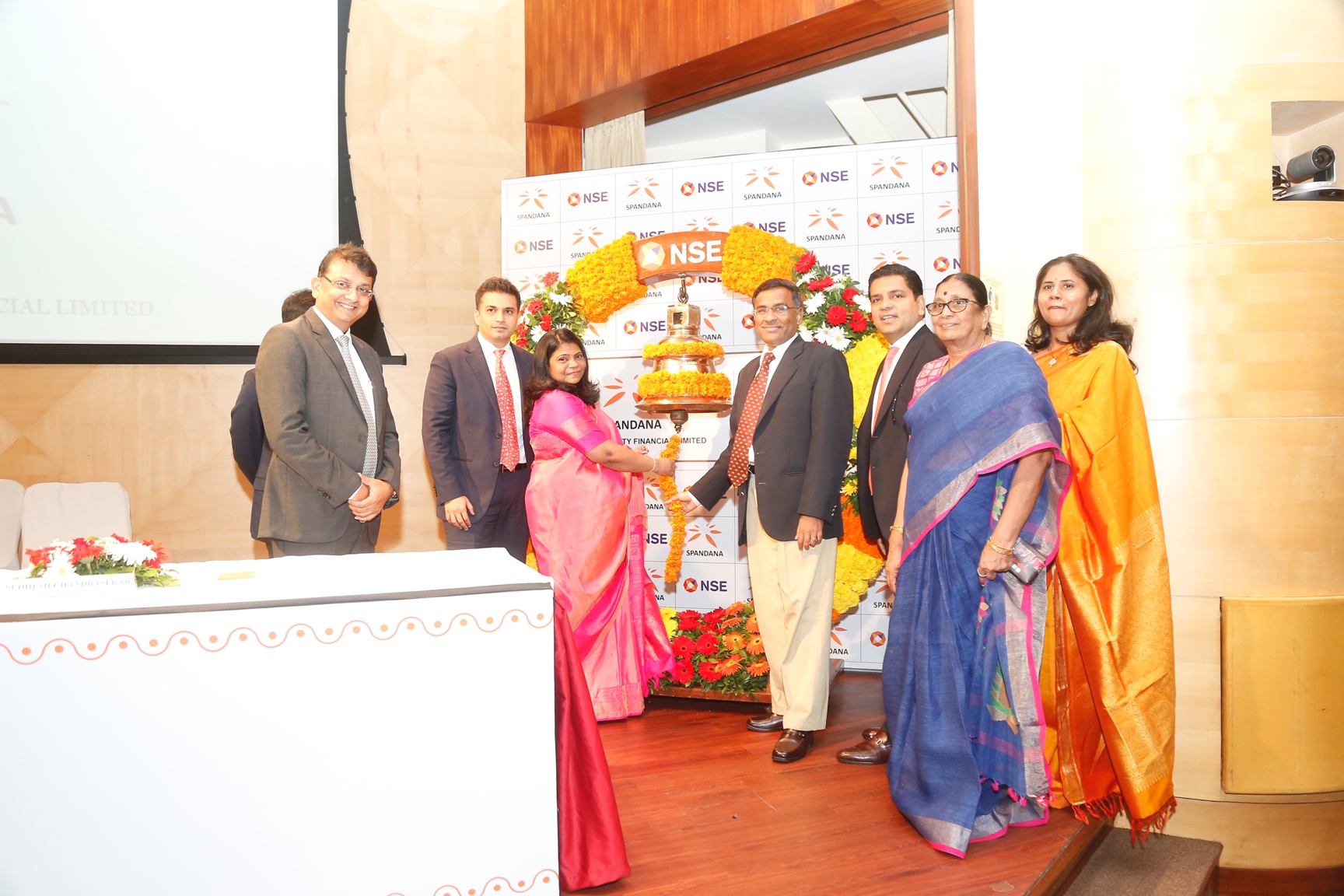 (In Centre L-R): Ms. Padmaja Gangireddy (Managing Director, Spandana Sphoorty Financial Limited) and Mr. Vikram Limaye (CEO and MD, NSE) and with other dignitaries present for the bell ringing ceremony at the listing of Spandana Sphoorty Financial Limited held today at NSE. Also seen in the picture, Mr. Ajay Saraf (ICICI Securities Limited), Mr Chirag Negandhi (Axis Capital Limited), Mr Sunish Sharma (Kedaara Capital) and family members of Ms. Padmaja Gangireddy. - Photo By GPN