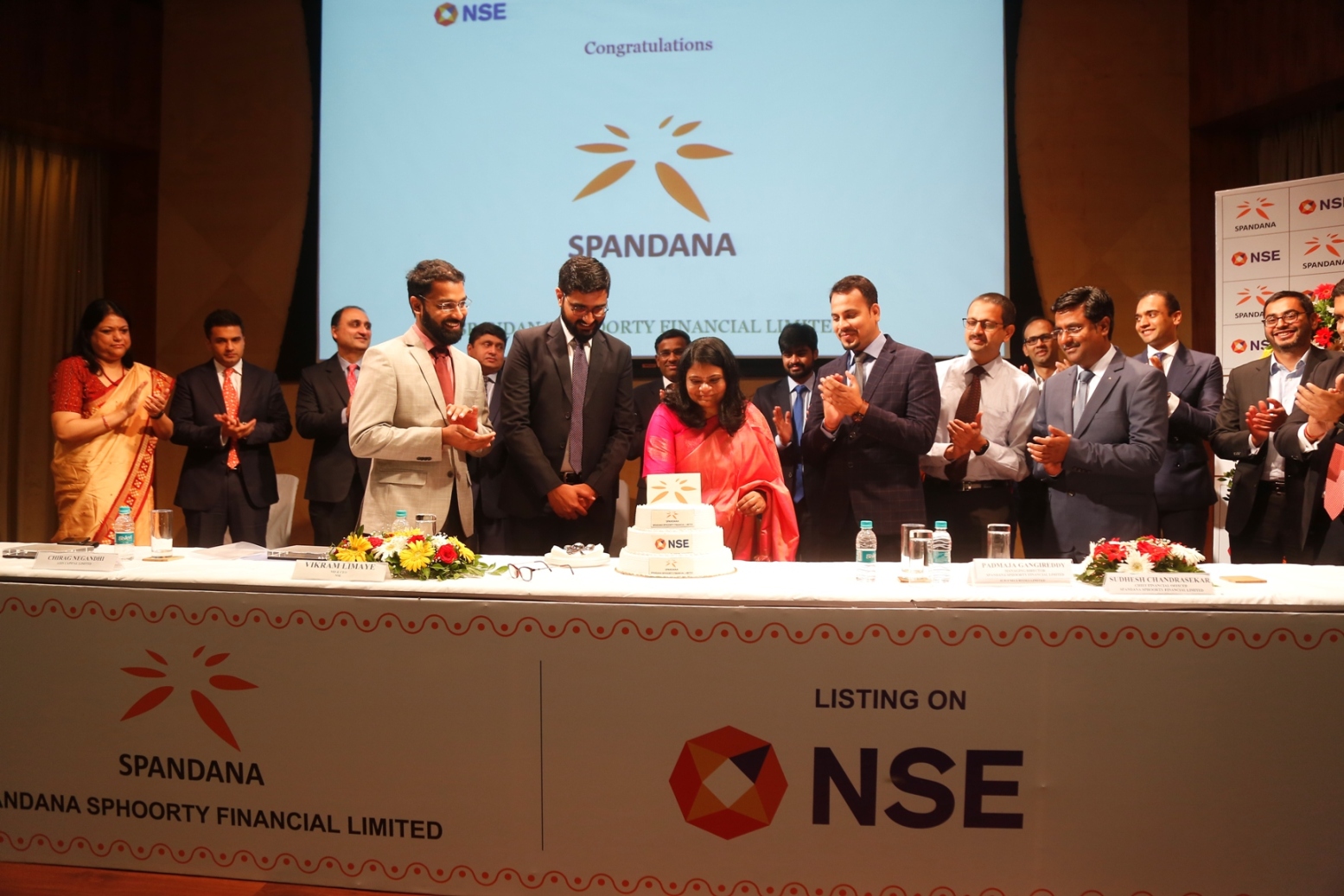 Ms. Padmaja Gangireddy (Managing Director, Spandana Sphoorty Financial Limited) cutting the cake with Spandana Sphoorty team and other dignitaries on the occasion of the listing ceremony of Spandana Sphoorty Financial Limited held today in Mumbai at NSE.-Photo By GPN
