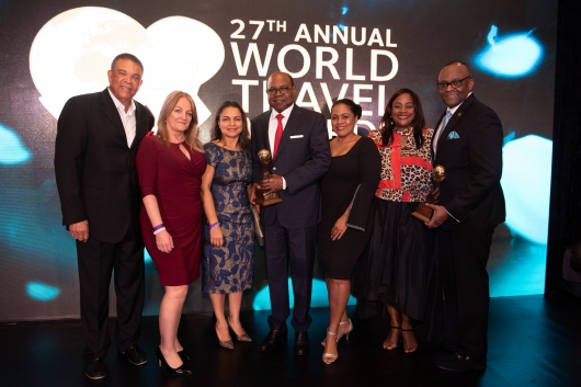 Jamaica's Minister of Tourism Hon. Edmund Bartlett (center) flanked by senior executives from the Jamaica Tourist Board. From left to right: Donnie Dawson, Deputy Director of Tourism, Sales; Elizabeth Fox, Regional Director, UK/N Europe; Francine Carter-Henry, Manager, Tour Operators & Airlines; Camile Glenister, Deputy Director of Tourism, Marketing; Angella Bennett, Regional Director, Canada and Donovan White, Jamaica's Director of Tourism 