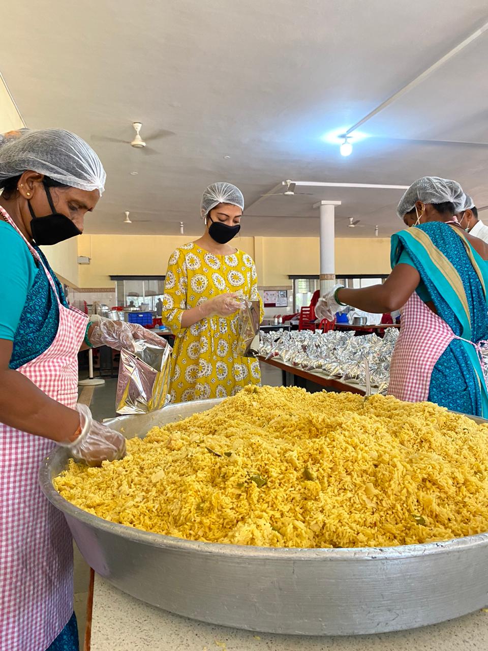 Actress Pranitha Subhash helping in preparation of meals and packing food boxes for daily wage workers and migrants.- Photo By GPN