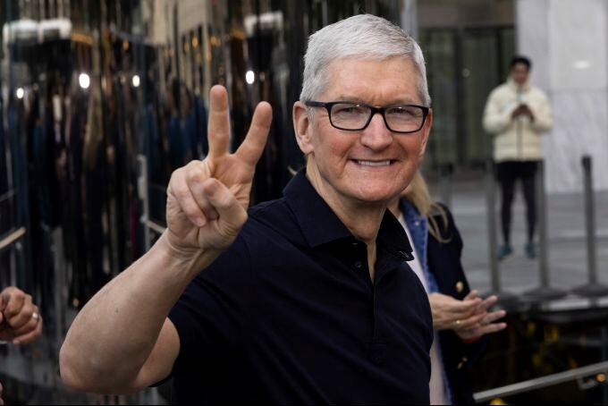 Apple CEO Tim Cook poses for a picture outside the Apple Fifth Avenue store for the release of the iPhone 14, Friday, Sept. 16, 2022, in New York.