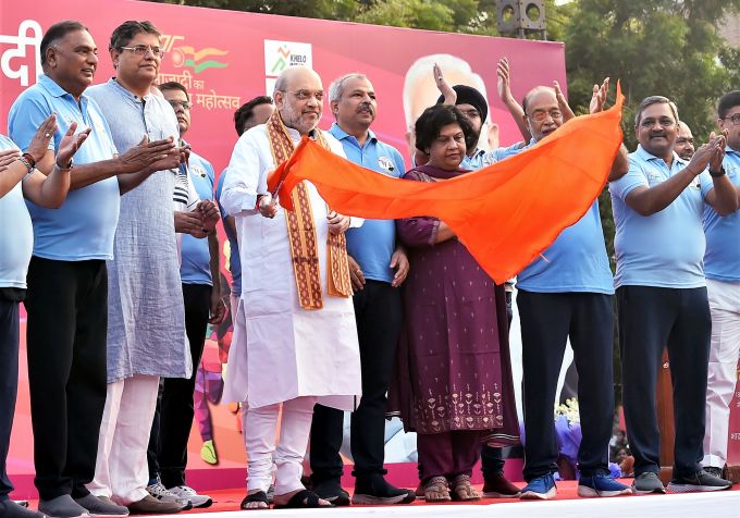 Union Home Minister Amit Shah flags off the 'Pradhanmantri Narendra Modi Cross-Country Slum Race' under 'Sewa Karyakram', at Major Dhyan Chand National Stadium in New Delhi, Sunday, Sept. 18, 2022. Delhi BJP President Adesh Gupta and other dignitaries are also seen.