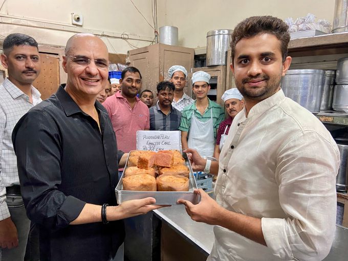 Pune: Co-owner of Kayani Bakery Rustom Kayani and Purandar Highlands FPC Chairman Rohan Ursal (right) show the red guava cake - 'Purandar Peru Eggless Cake' prepared at the Kayani Bakery, in Pune.